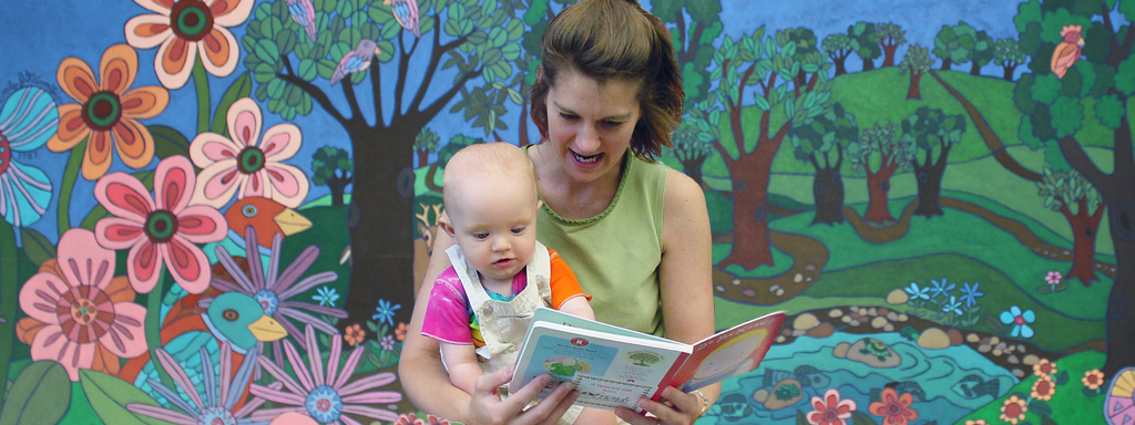 Woman reading to a baby.