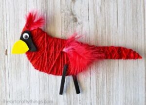 Cardinal craft made of string, cardboard, and feathers