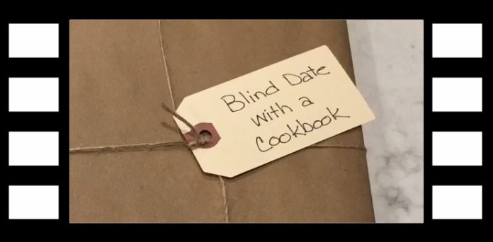 Brown paper wrapped book with a paper tag reading Blind Date with a Cookbook.