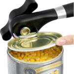 Manual can opener being used to open a can of corn.