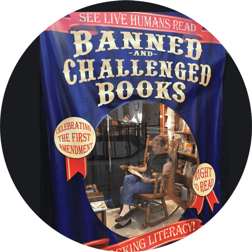 display: "See live humans read Banned & Challenged Books. Celebrate the first amendment right to read. Shocking literacy!" Woman reading a book in a rocking chair.