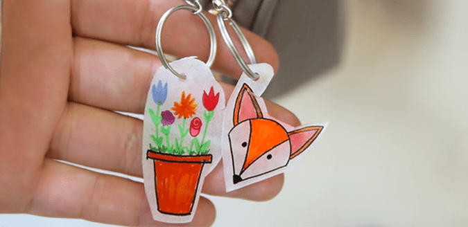 Shrinky Dink key chain with a fox and a flower pot on it.