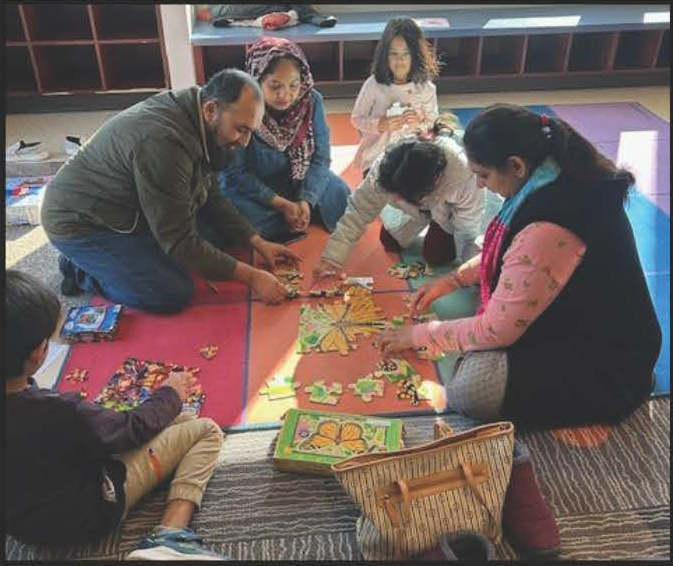 A family working together on a puzzle during Puzzle Day