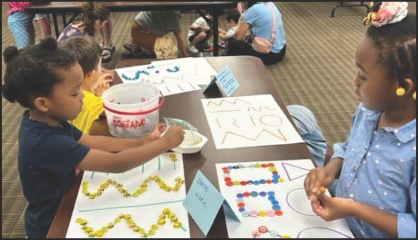 Young patrons doing a craft at a Summer Reading event