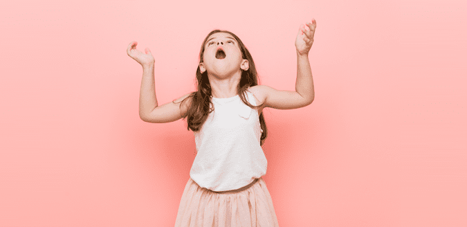 Girl raising her hands and dramatically speaking