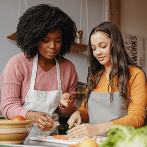 A woman and a teenager cooking together