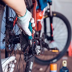 Close up of a mechanic fixing a bike.