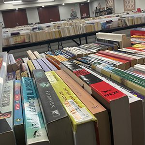 Books lined up on tables at a book sale
