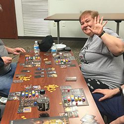 Adults playing a board game together.