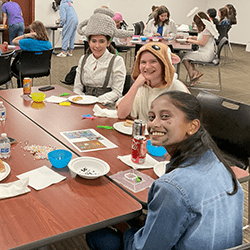 Teentober Fest 2024 - teens in costumes eating pizza and doing crafts
