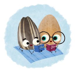 Two seeds reading together on a blanket